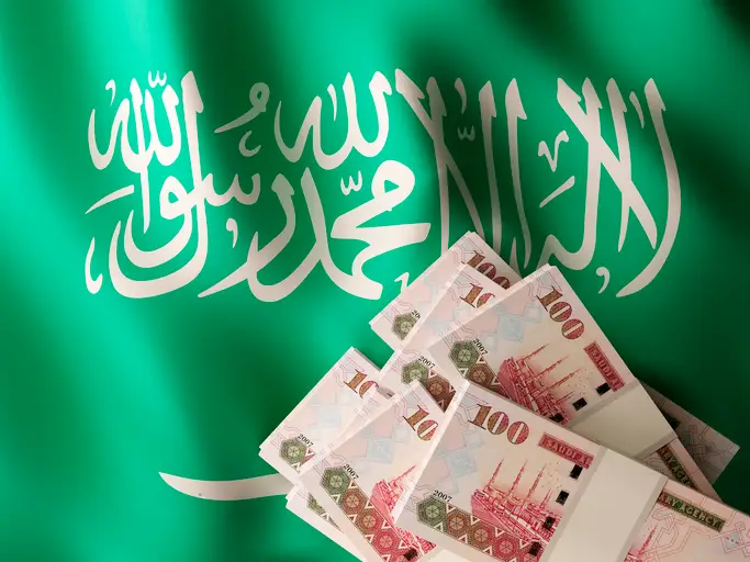 Saudi Riyal banknote bundles on textile textured Saudi Arabian flag. 3d rendered illustration.
